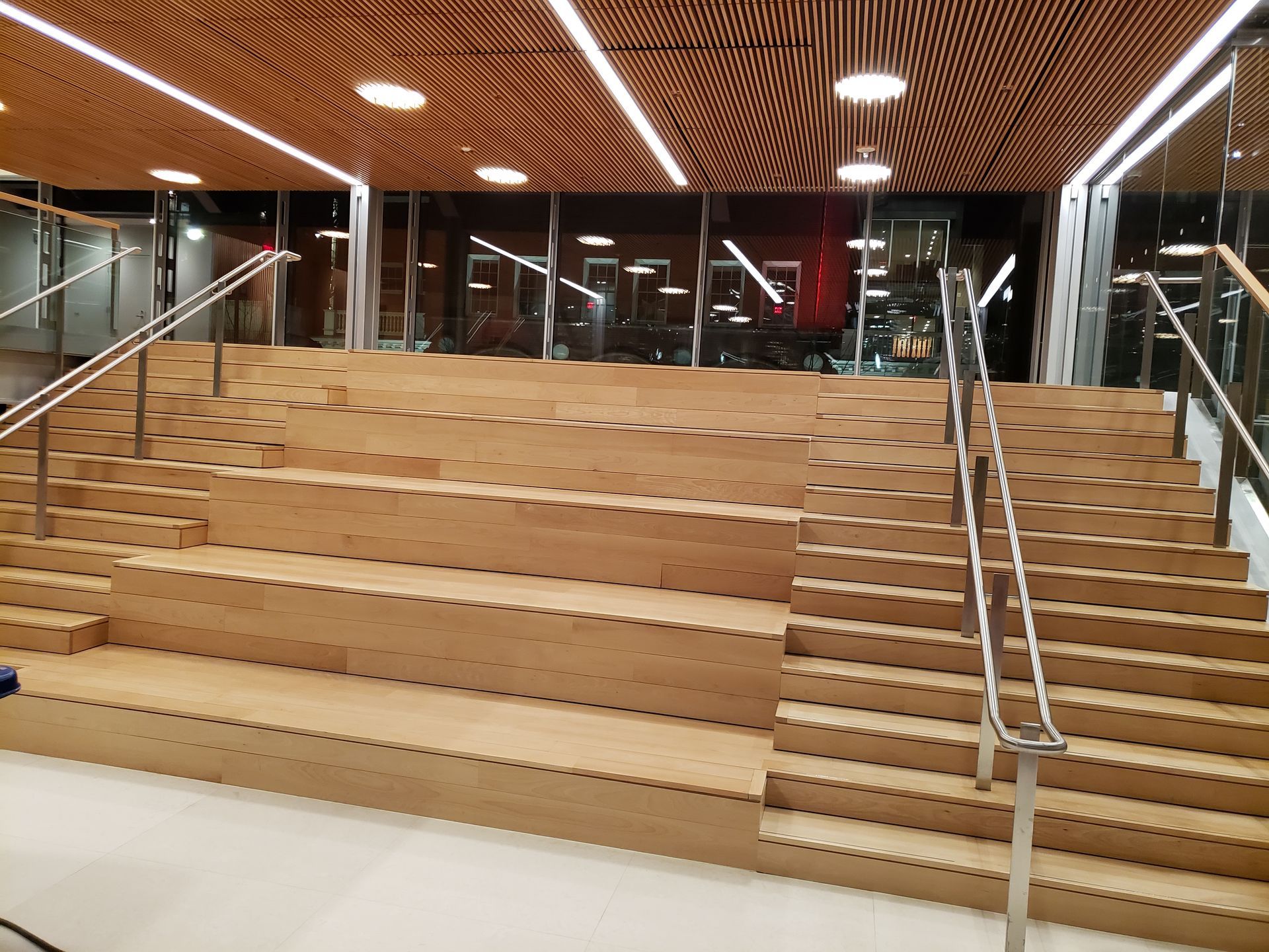 A large wooden staircase with a metal railing in a building