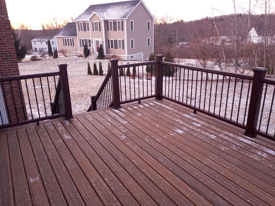 A deck with stairs leading up to a house