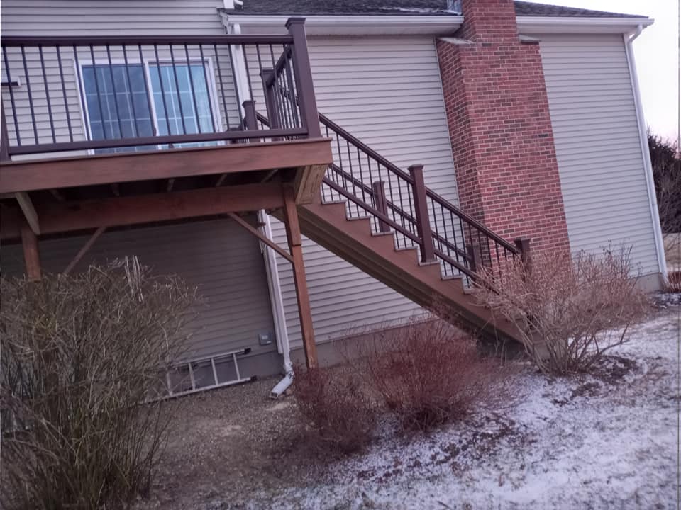 A house with a deck and stairs leading up to it