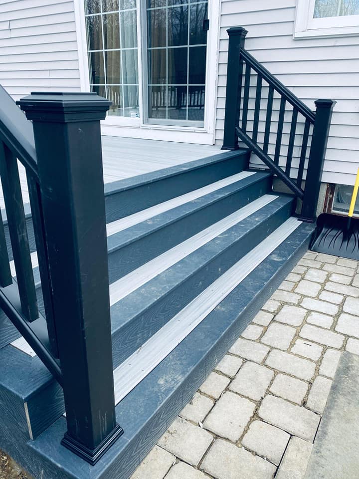 The stairs are painted black and white and the railing is black.