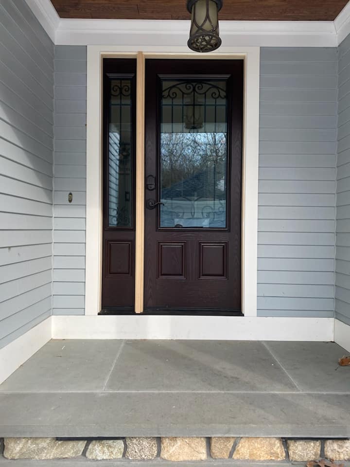 The front door of a house with a lantern hanging from the ceiling
