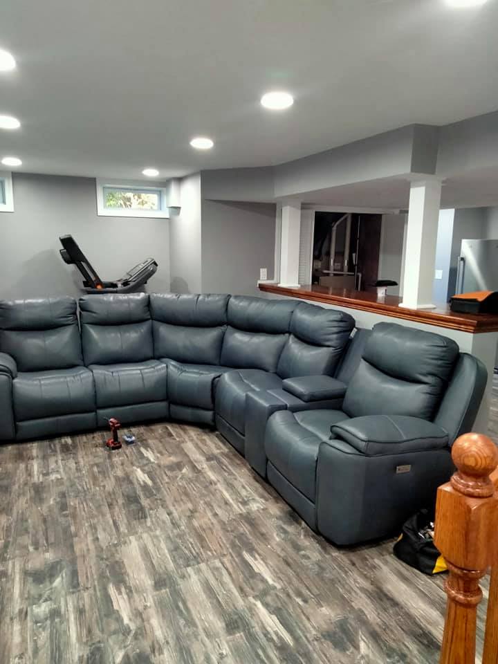 There is a large sectional couch in the middle of the room.
