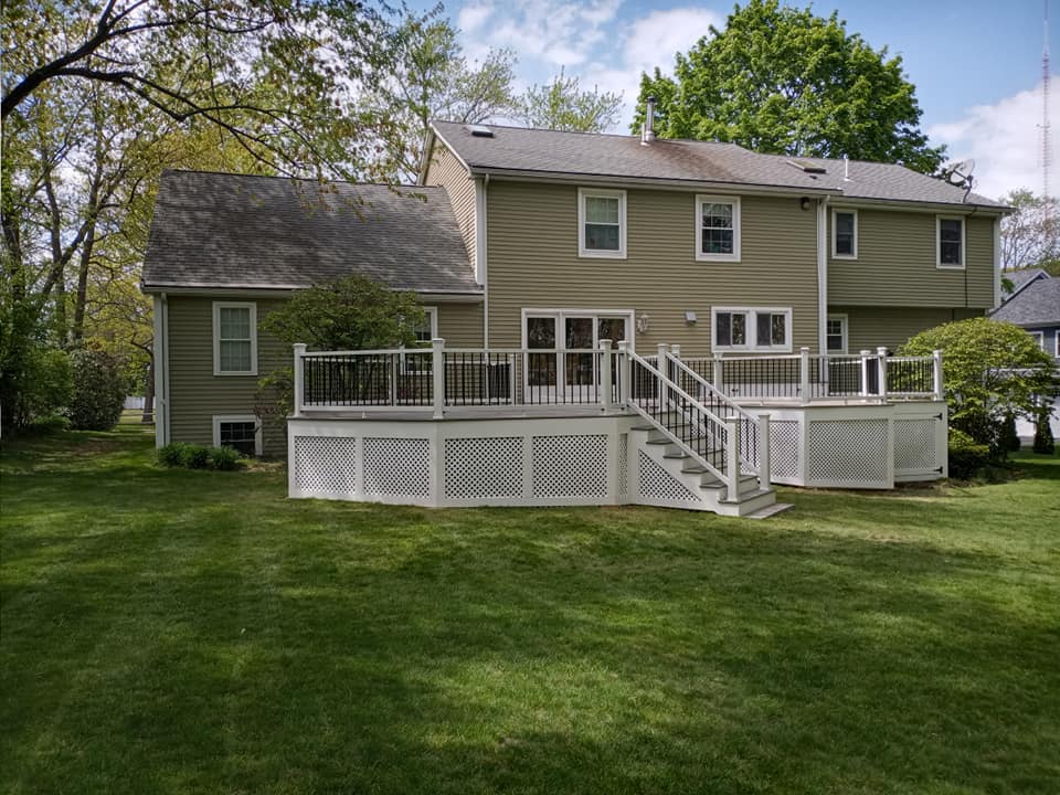 The back of a house with a large deck and stairs