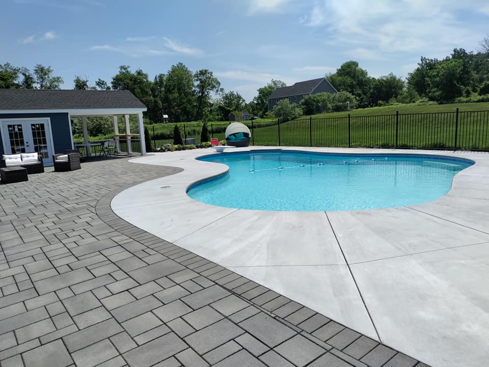 A large swimming pool with a fence around it