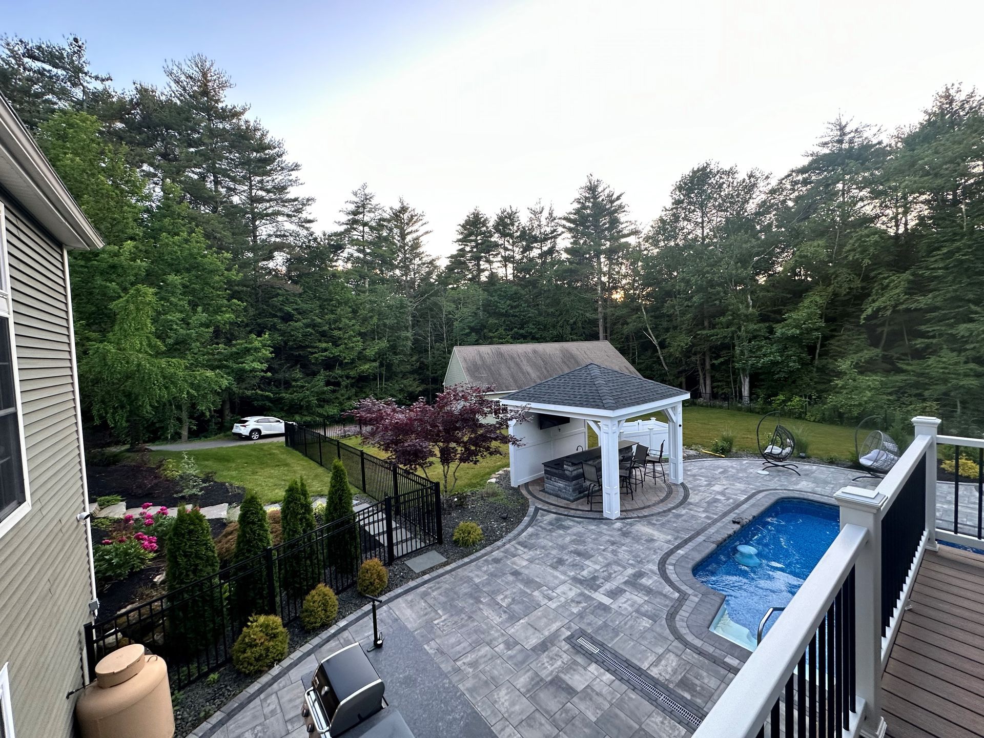 An aerial view of a backyard with a swimming pool
