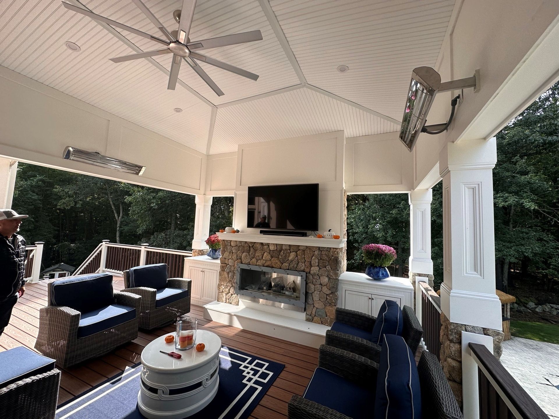 A living room with a fireplace and a ceiling fan