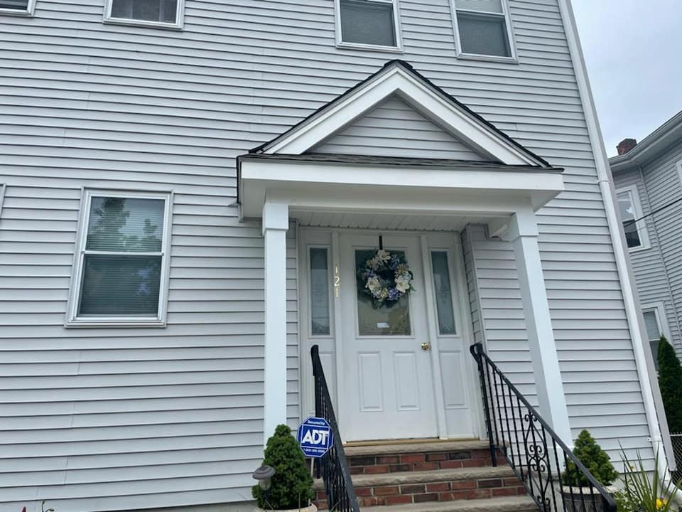The front door of a house with a wreath on it.