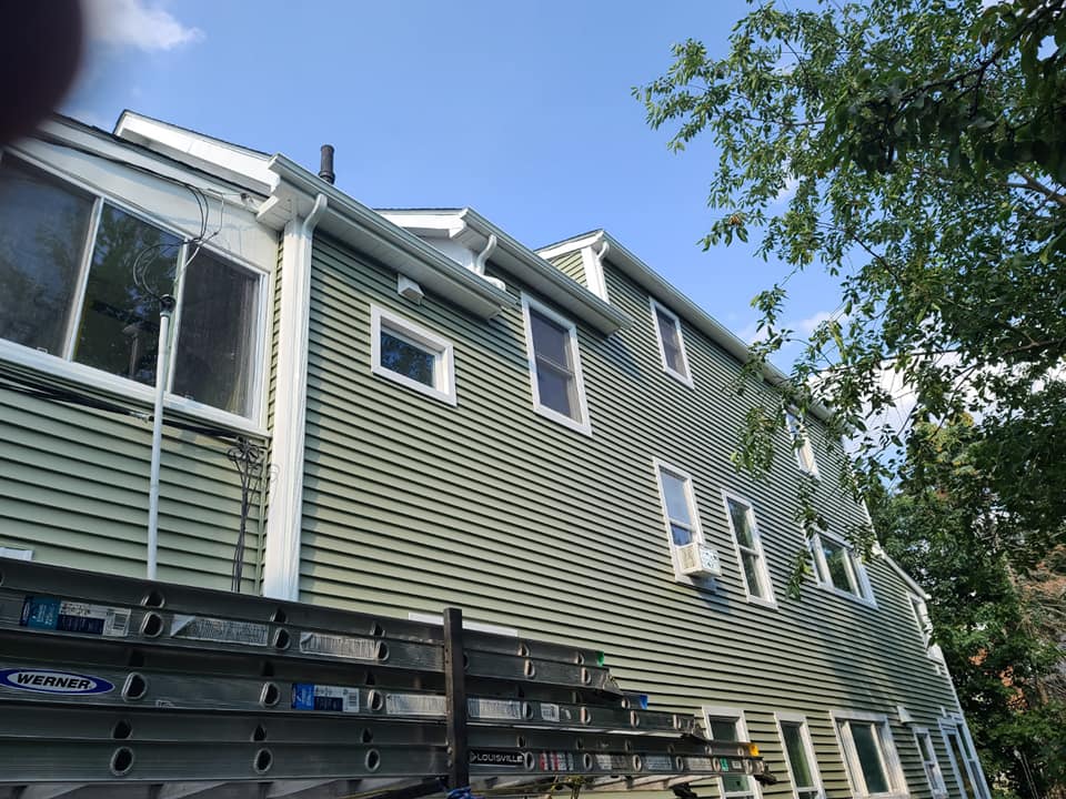 A large house with a deck and a blue sky in the background