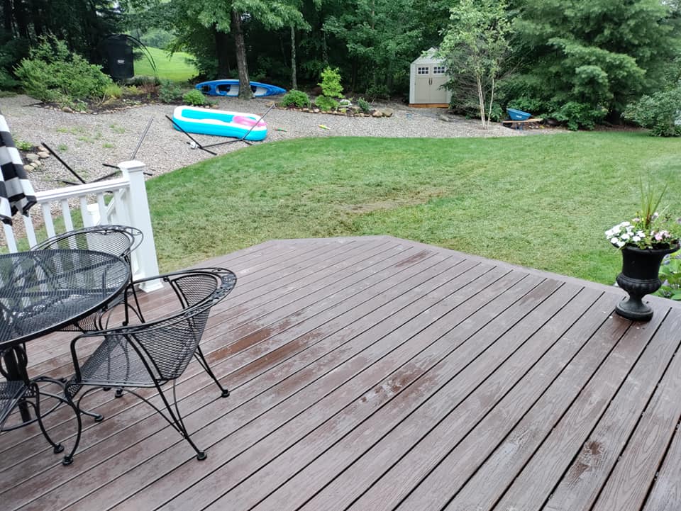 A wooden deck with a table and chairs on it