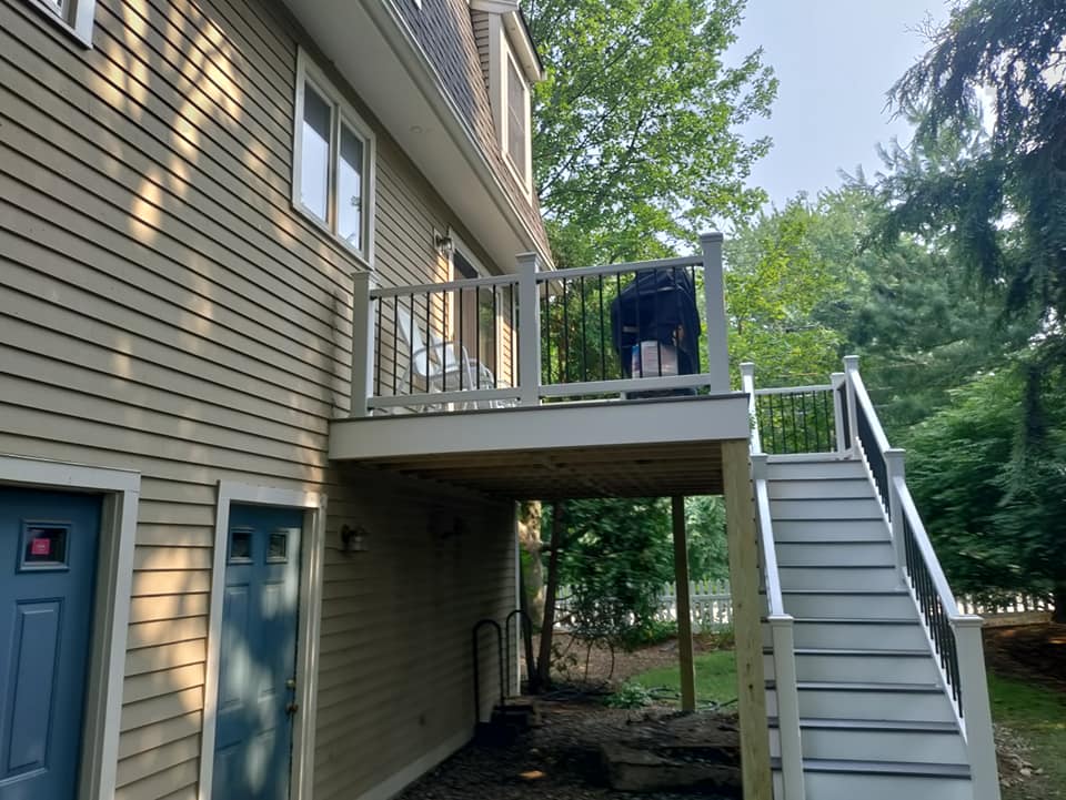A house with a deck and stairs leading up to it