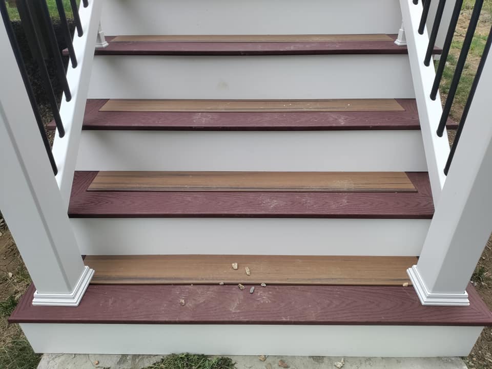 A set of stairs with wooden steps and a white railing