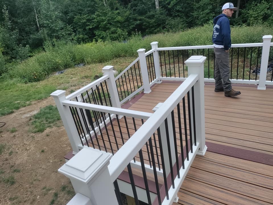 A man standing on a deck with a white railing