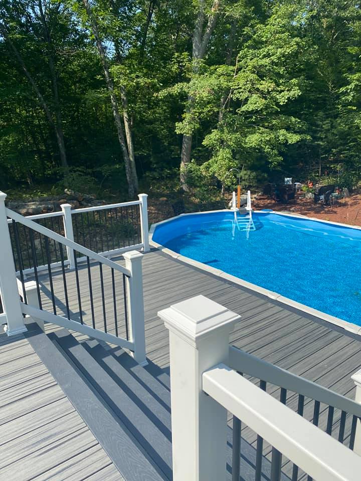 A man standing on a deck with a white railing