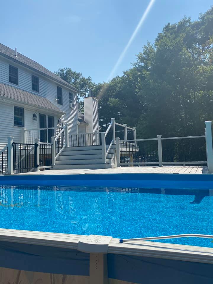 A large swimming pool in front of a house