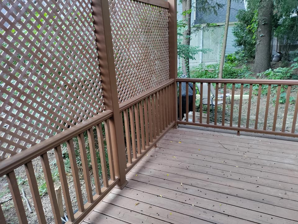 A wooden deck with a lattice fence surrounding it