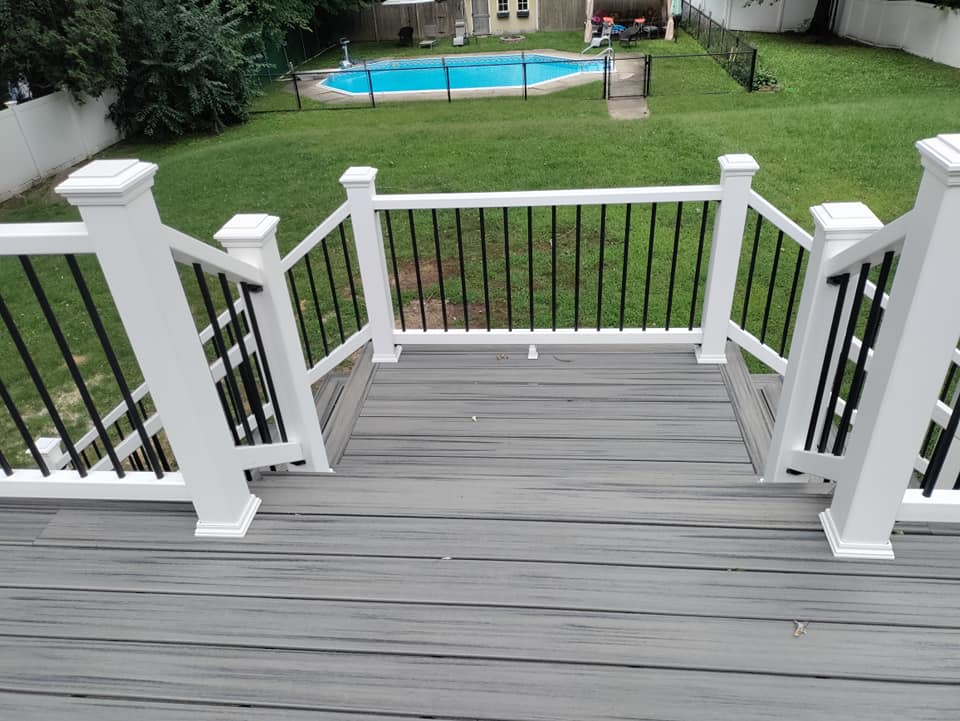 A deck with stairs leading up to a swimming pool