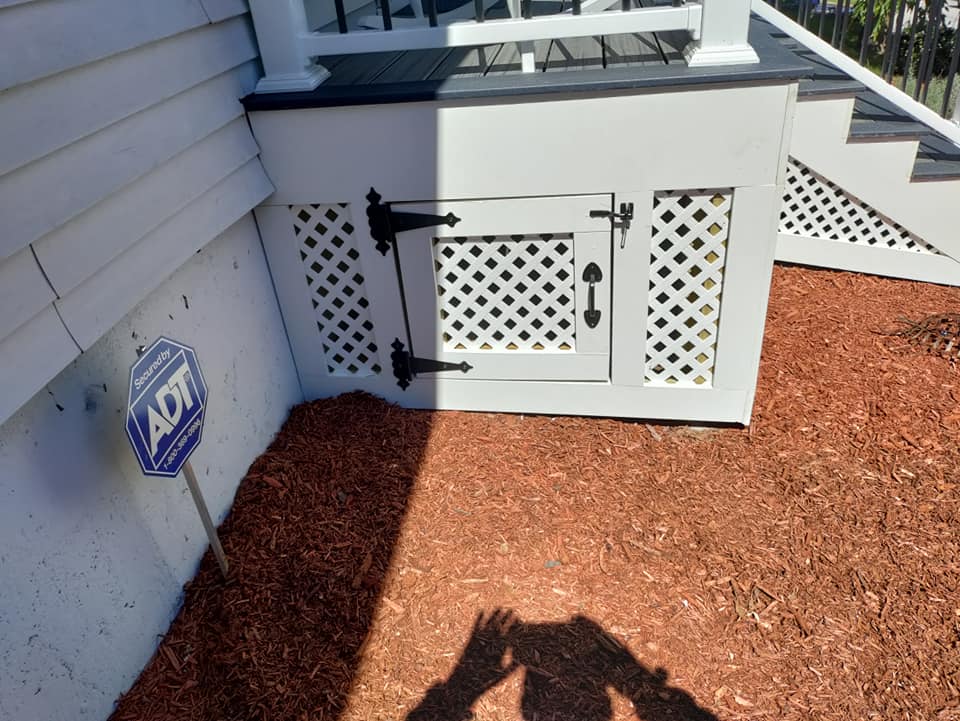 A shadow of a person is cast on the ground next to a sign that says act