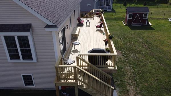An aerial view of a house with a large wooden deck.