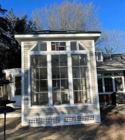 A house with a large window on the side of it