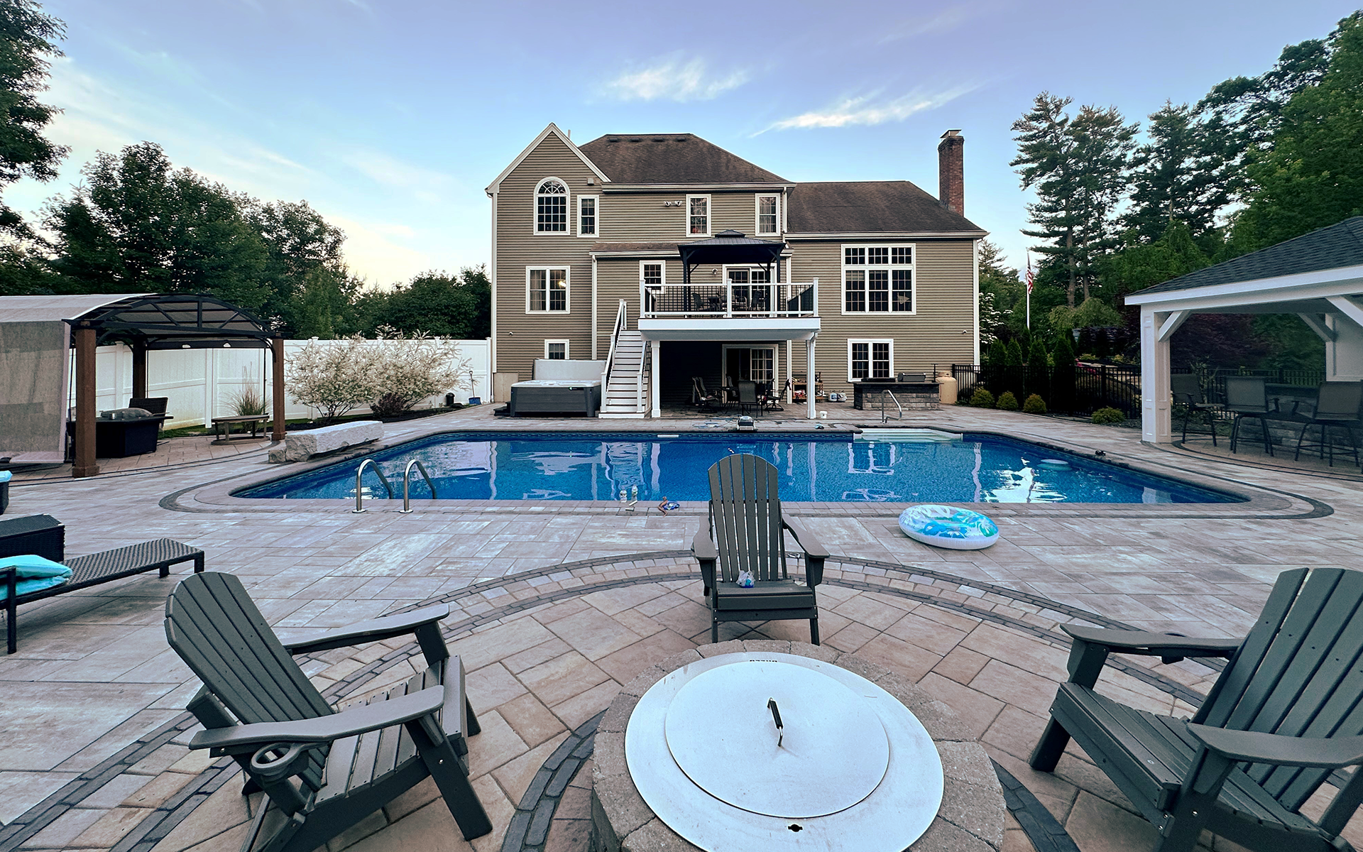 A large house with a large swimming pool in front of it