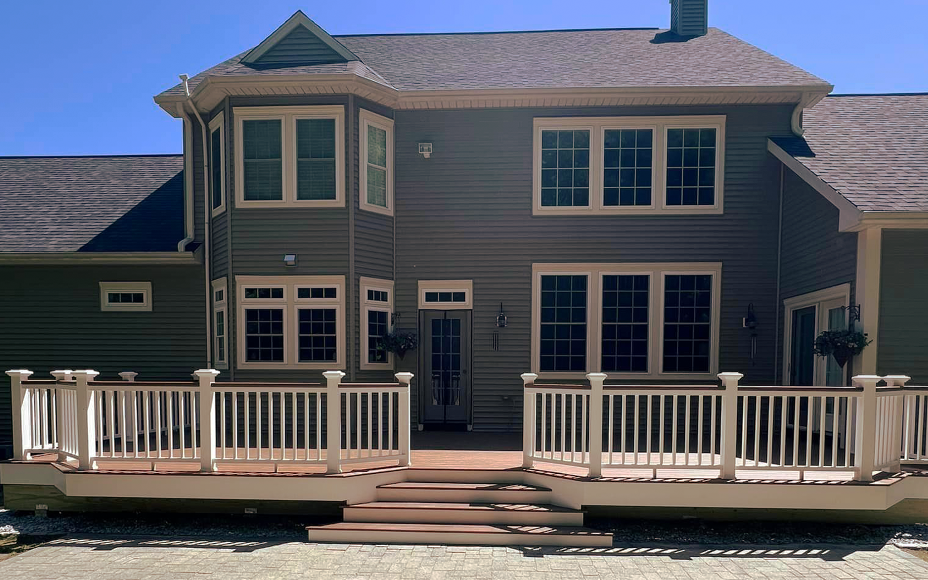 A large house with a large deck in front of it