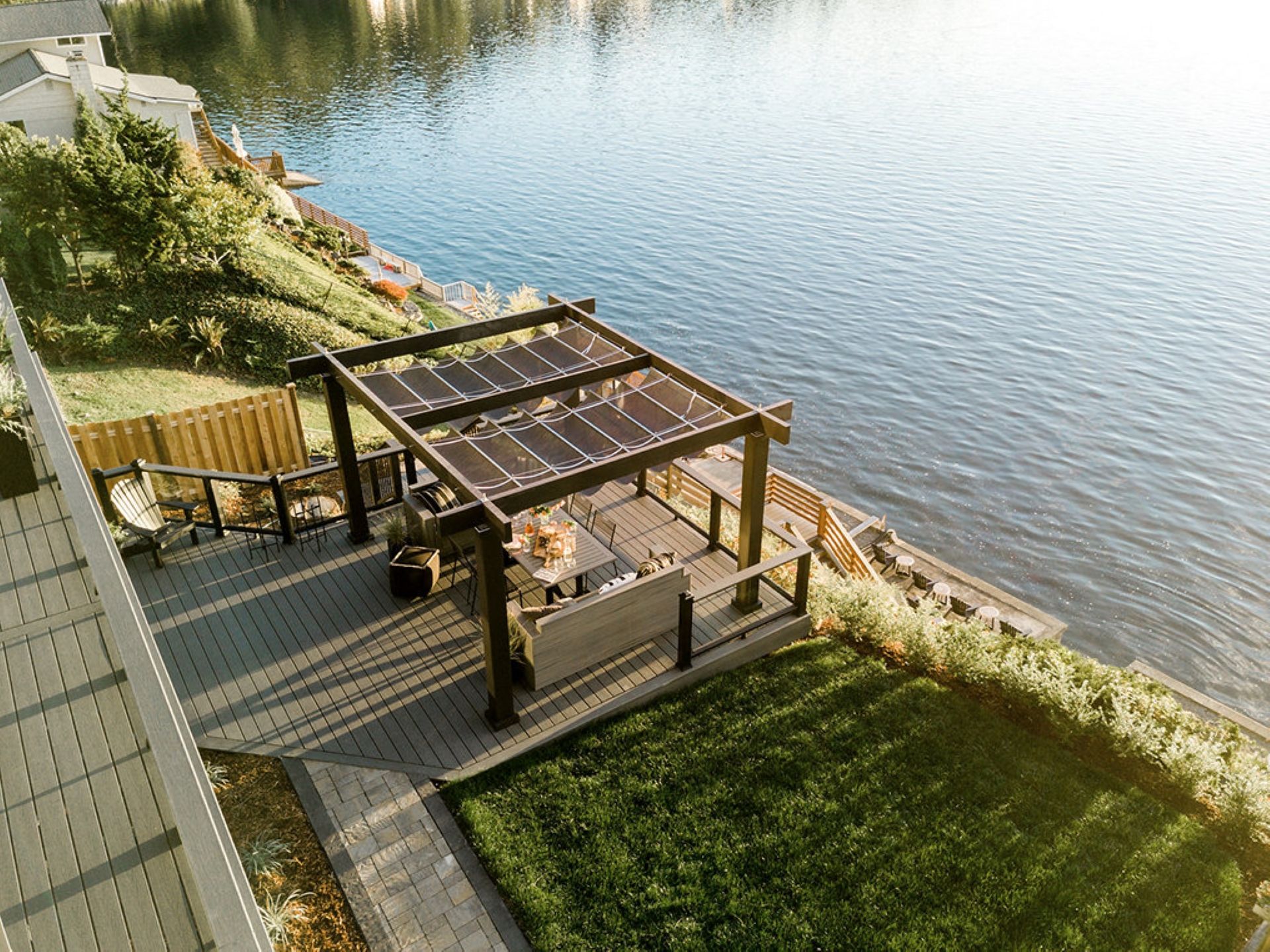 An aerial view of a pergola overlooking a lake.