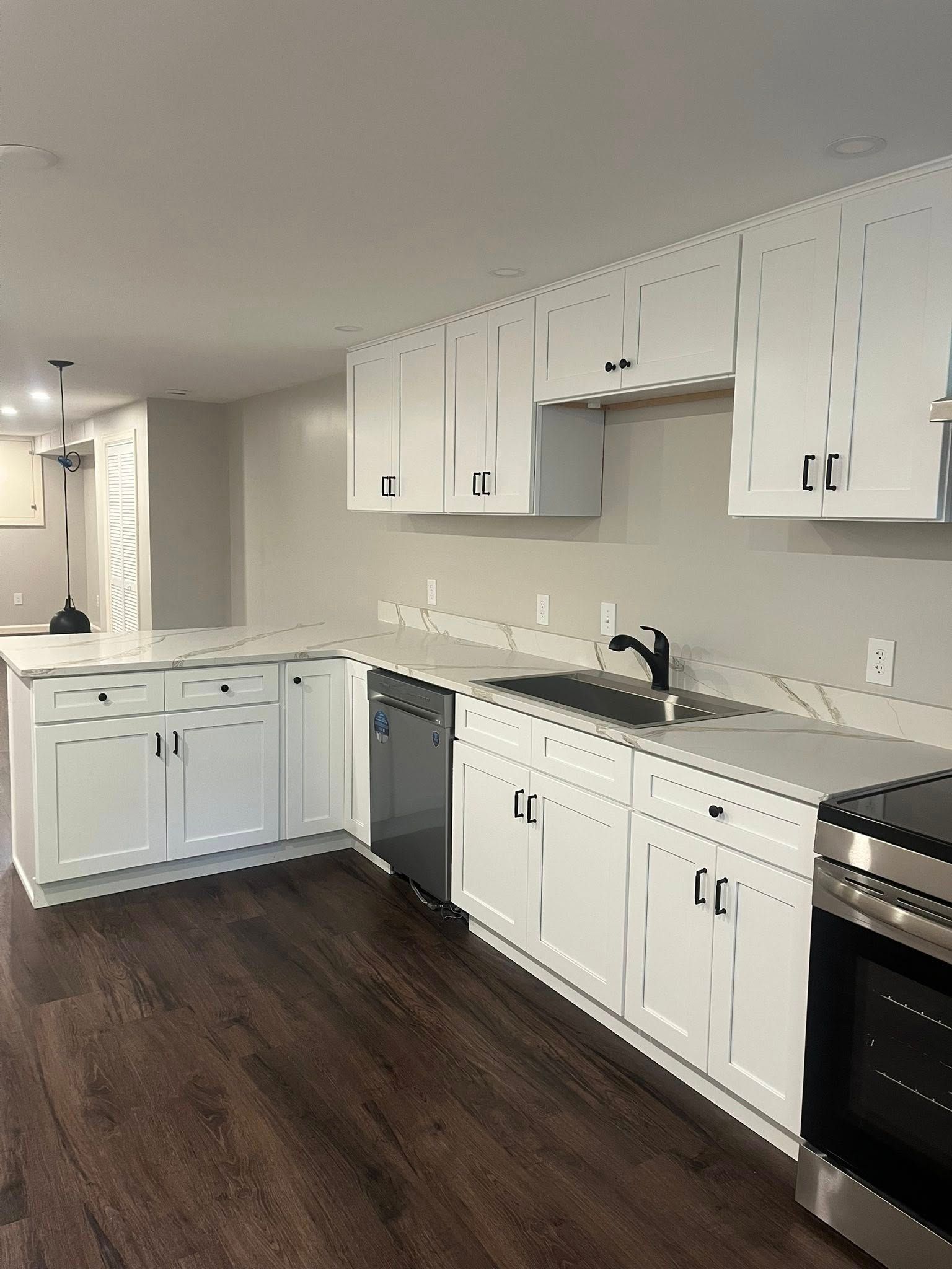 A kitchen with white cabinets and stainless steel appliances