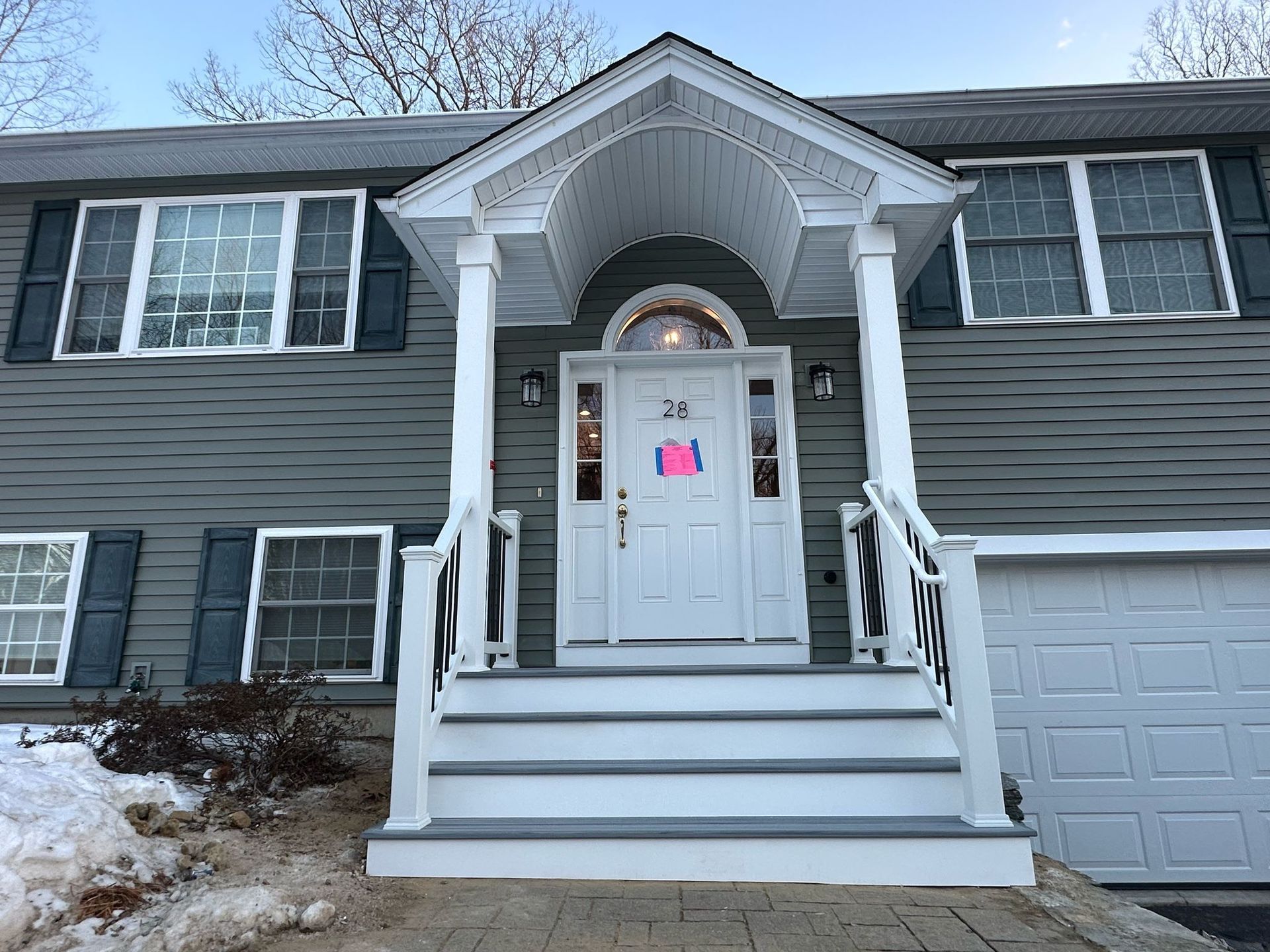 The front of a house with a porch and stairs