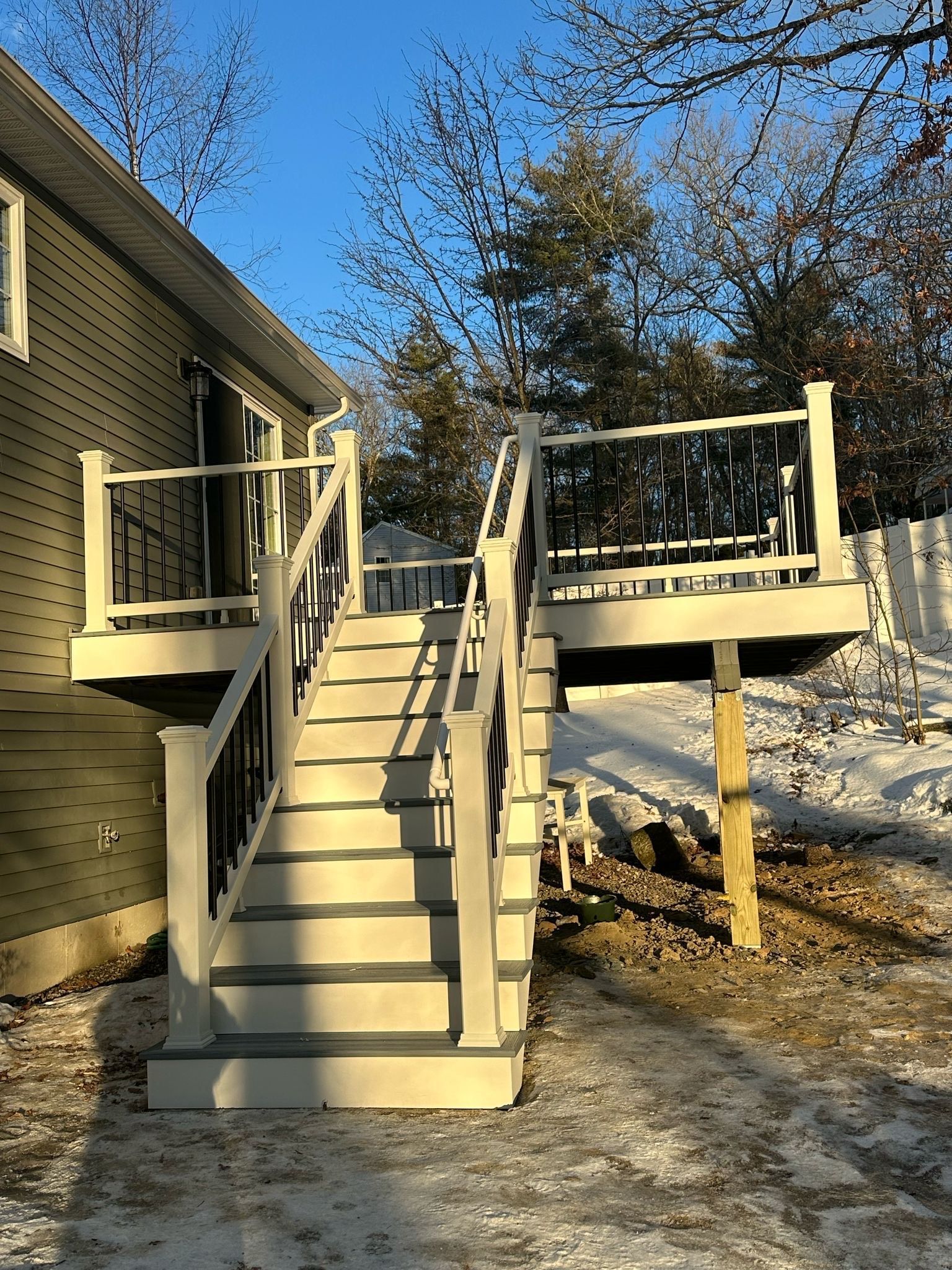 There is a deck with stairs leading up to it.