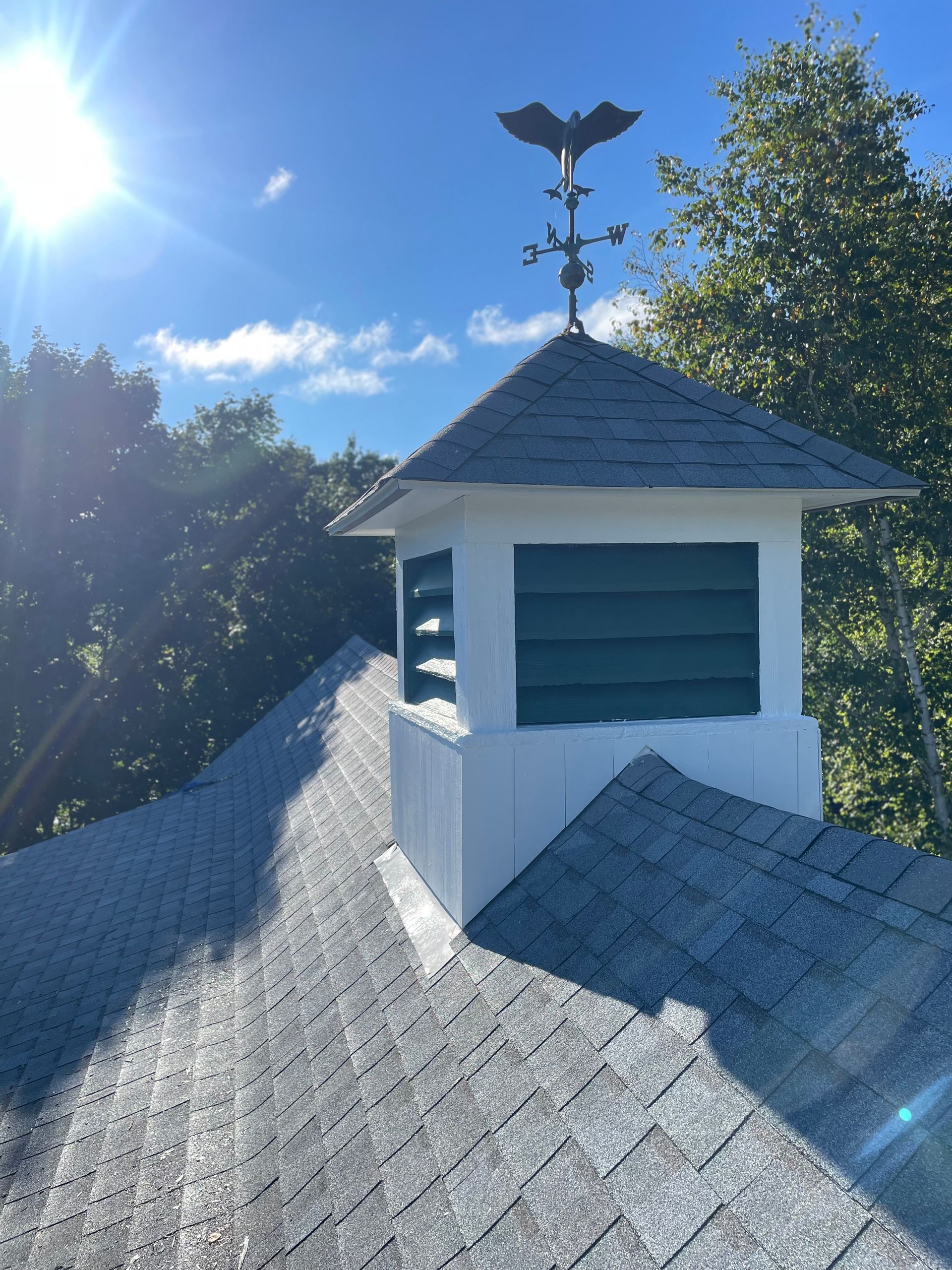 A roof with a weather vane on top of it