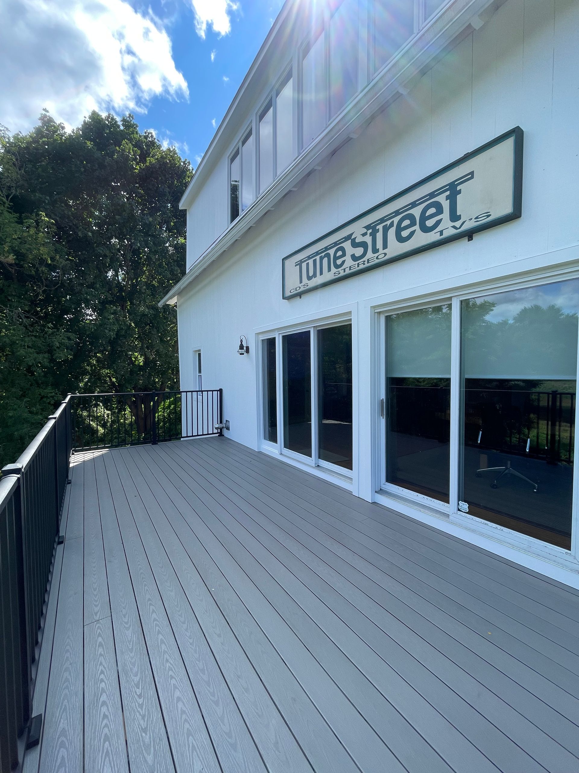 A large white building with a large deck in front of it