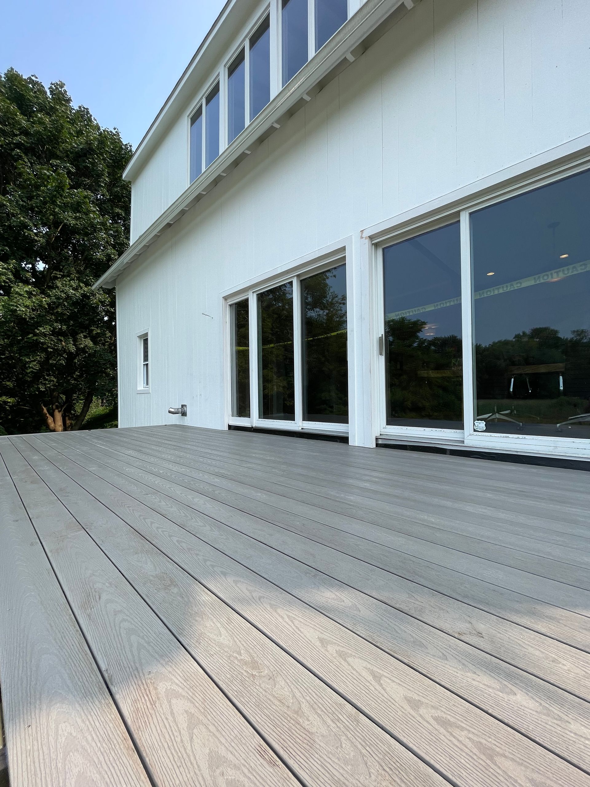 A large white building with a wooden deck in front of it