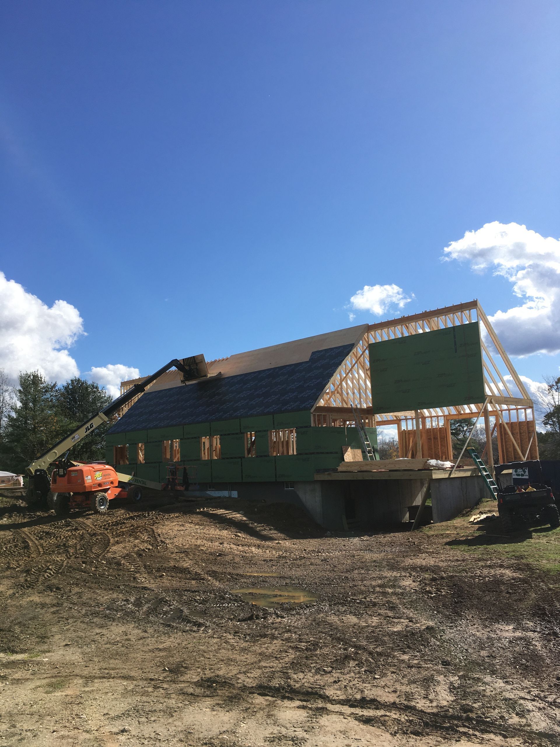 A large building is being built in a dirt field.