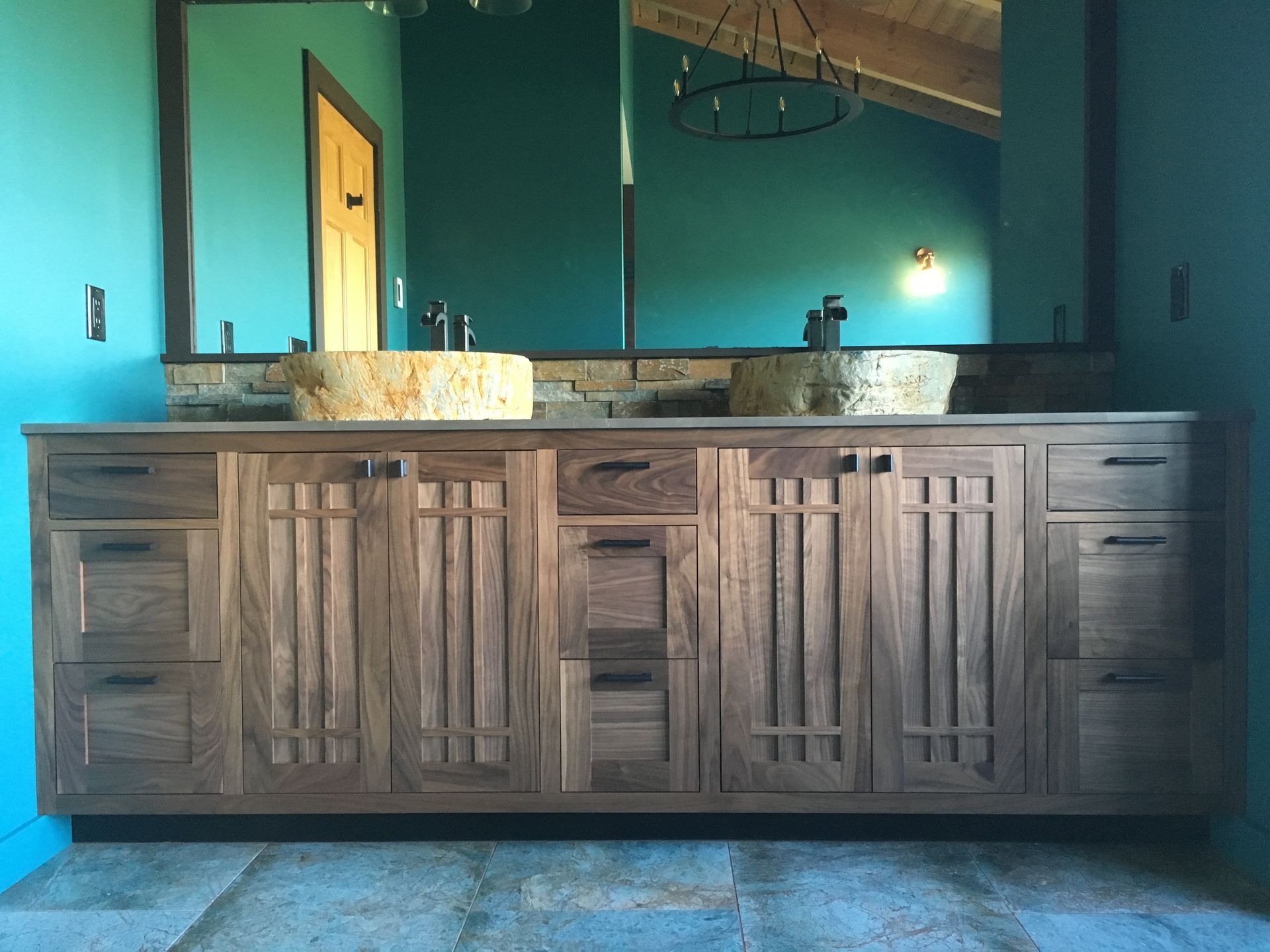 A bathroom with two sinks and a large mirror