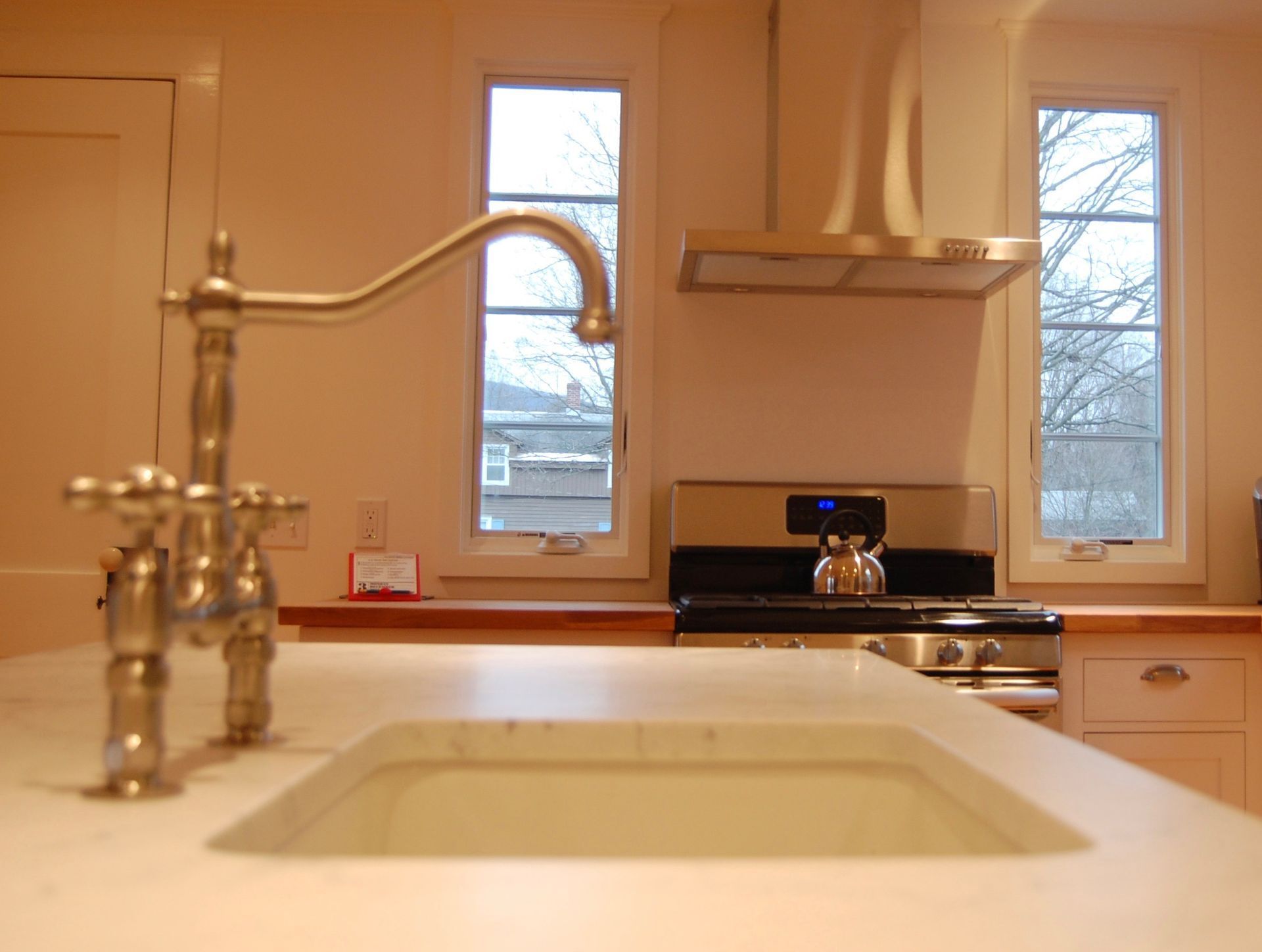 A kitchen with a sink and a stove top oven