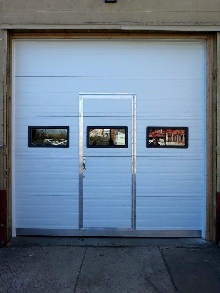 White garage door with three small windows and a center door.