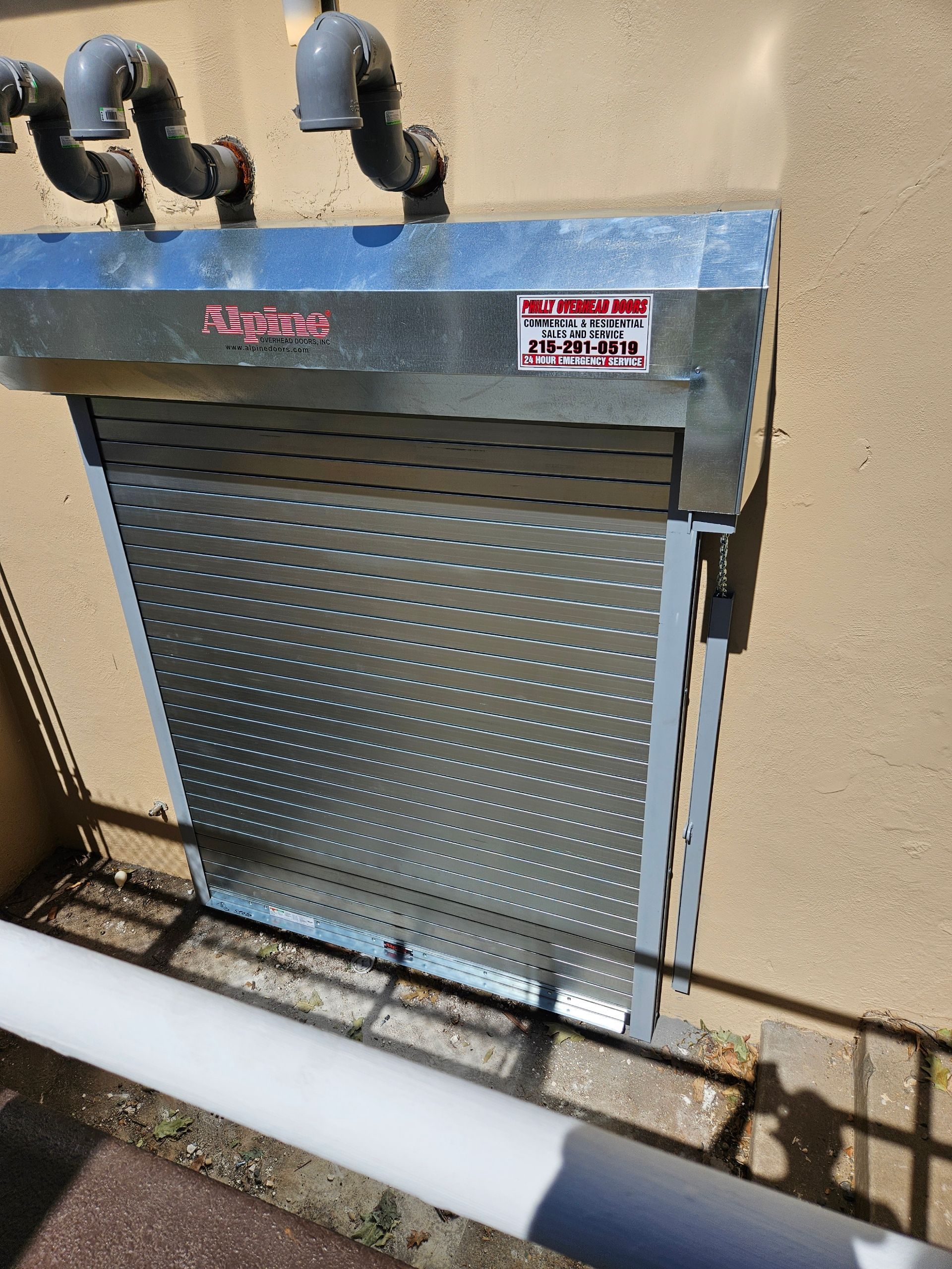 Metal rolling security shutter on a building exterior.