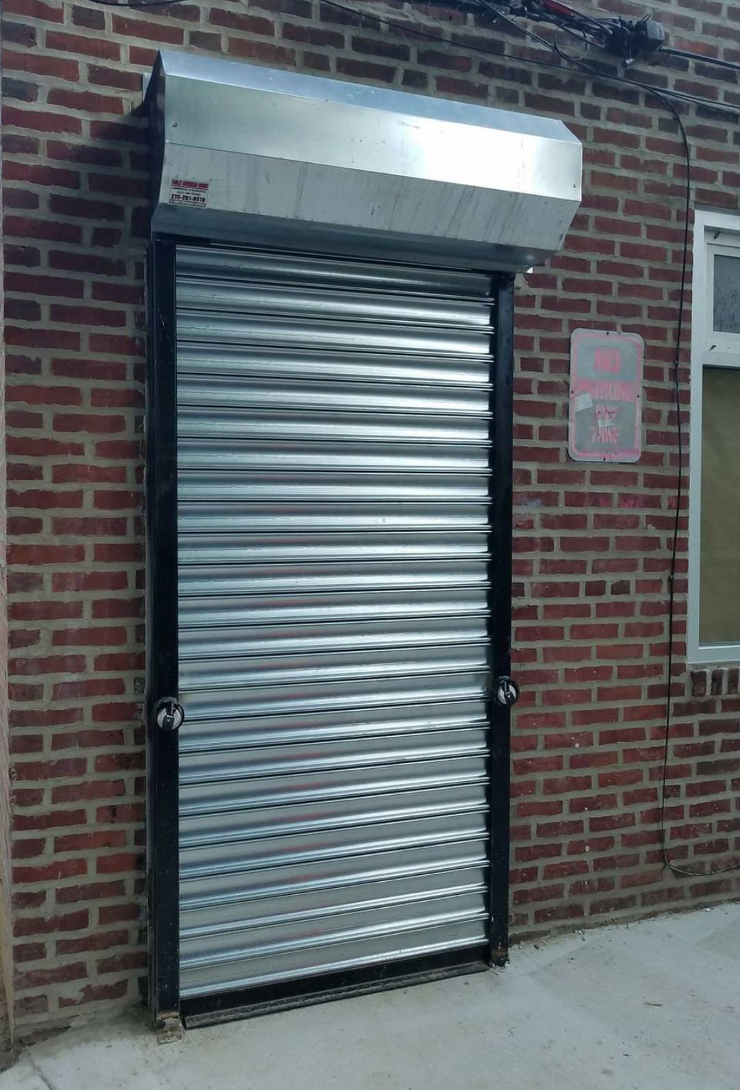 Metal roll-up door in a brick building.