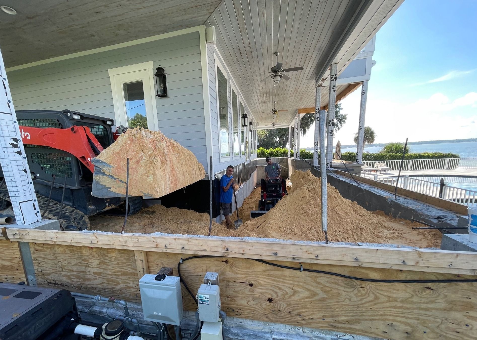 A large pile of dirt is sitting in front of a house.