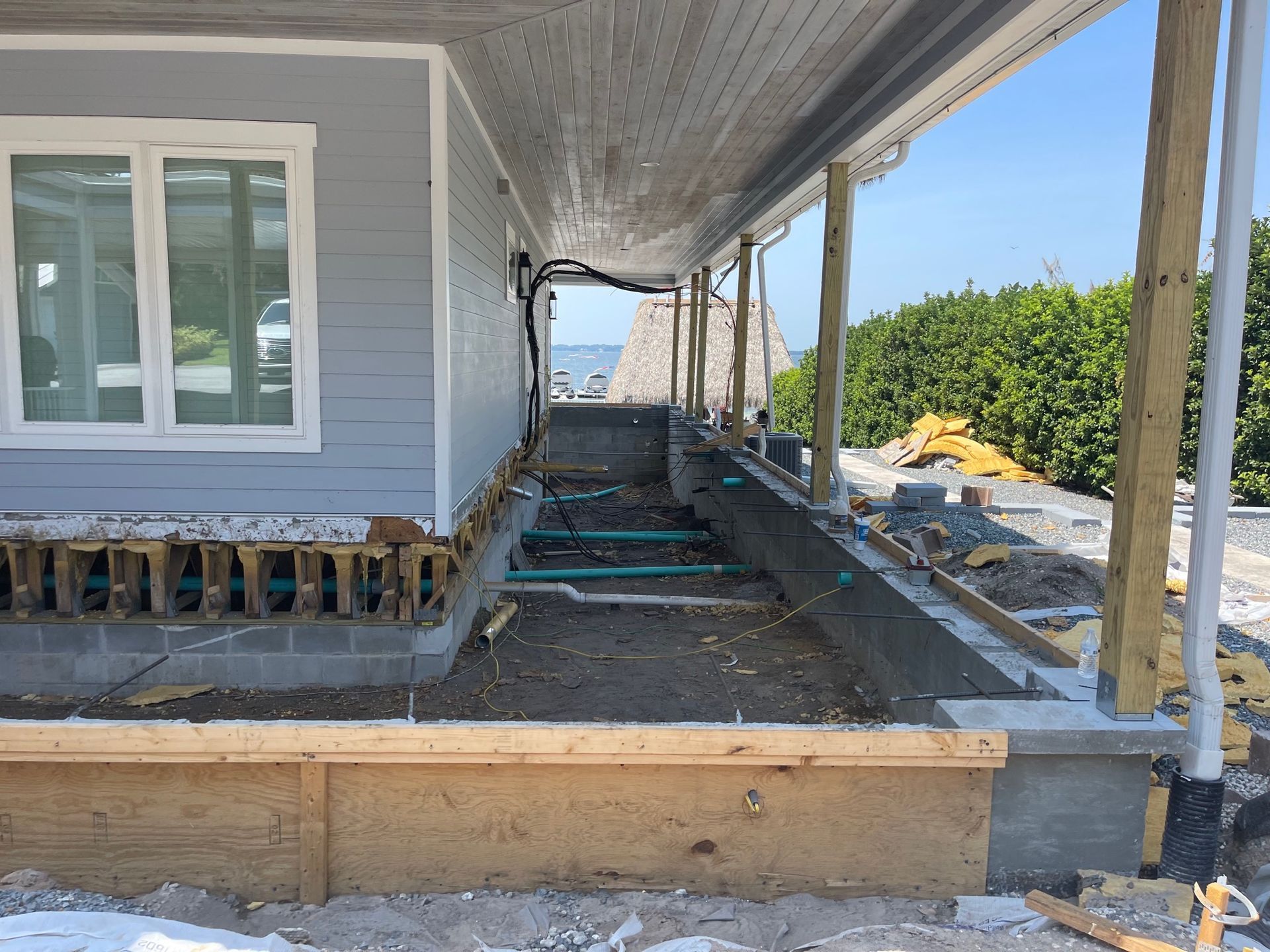 A house is being built with a porch and a view of the ocean.
