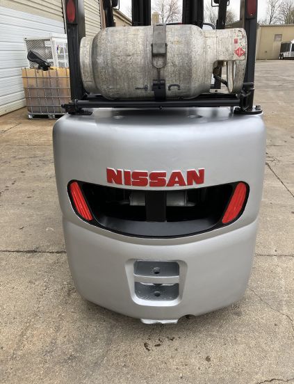 A nissan forklift is parked in a parking lot