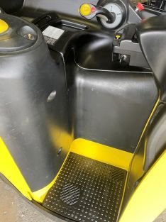 A close-up of the inside of a yellow and black forklift
