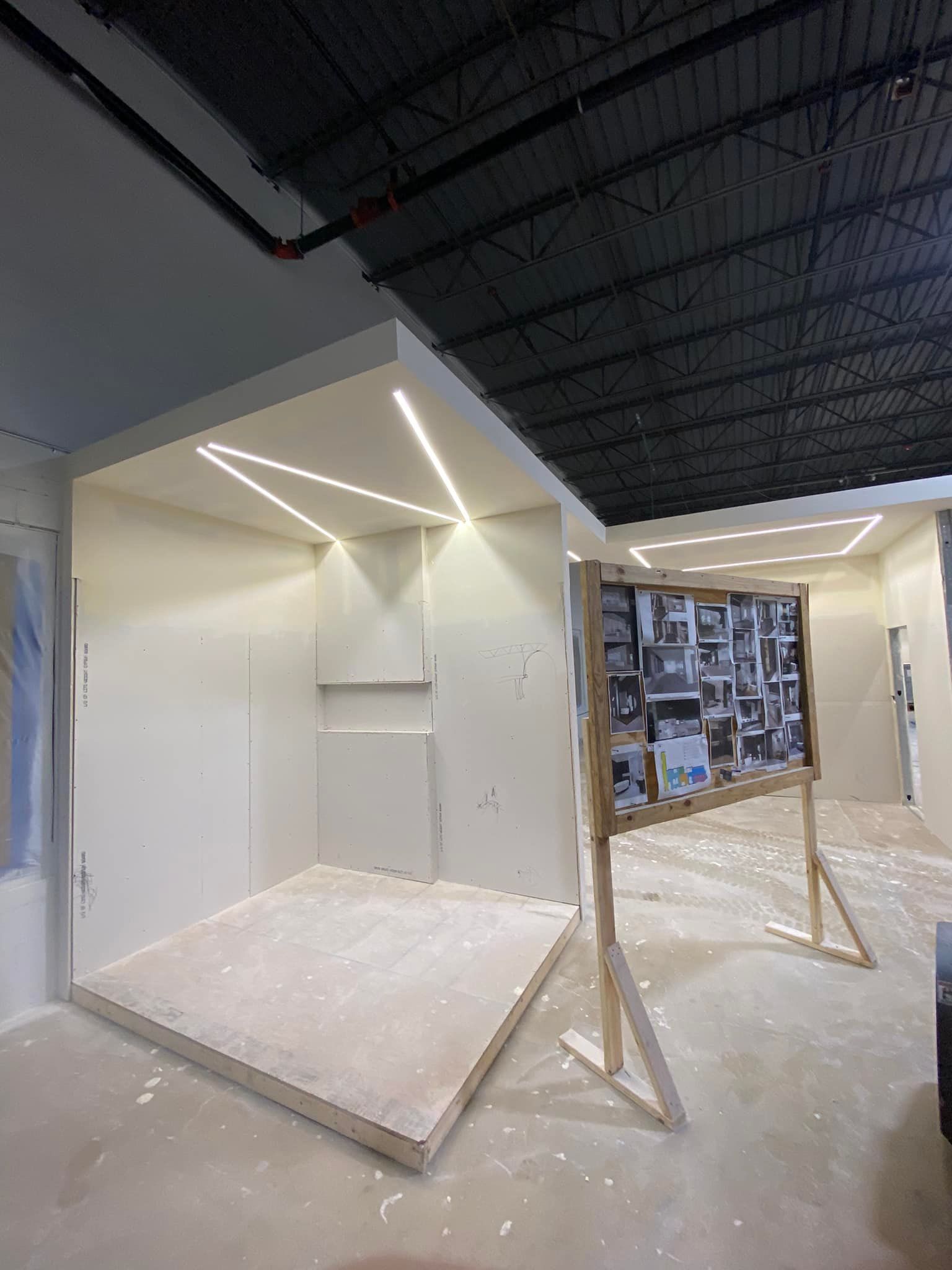 A room with a wooden floor and a ceiling that is being built.