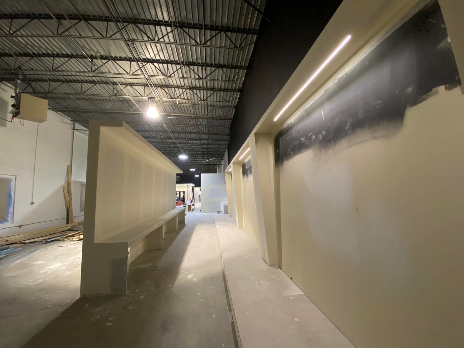 A long hallway in a building that is being built
