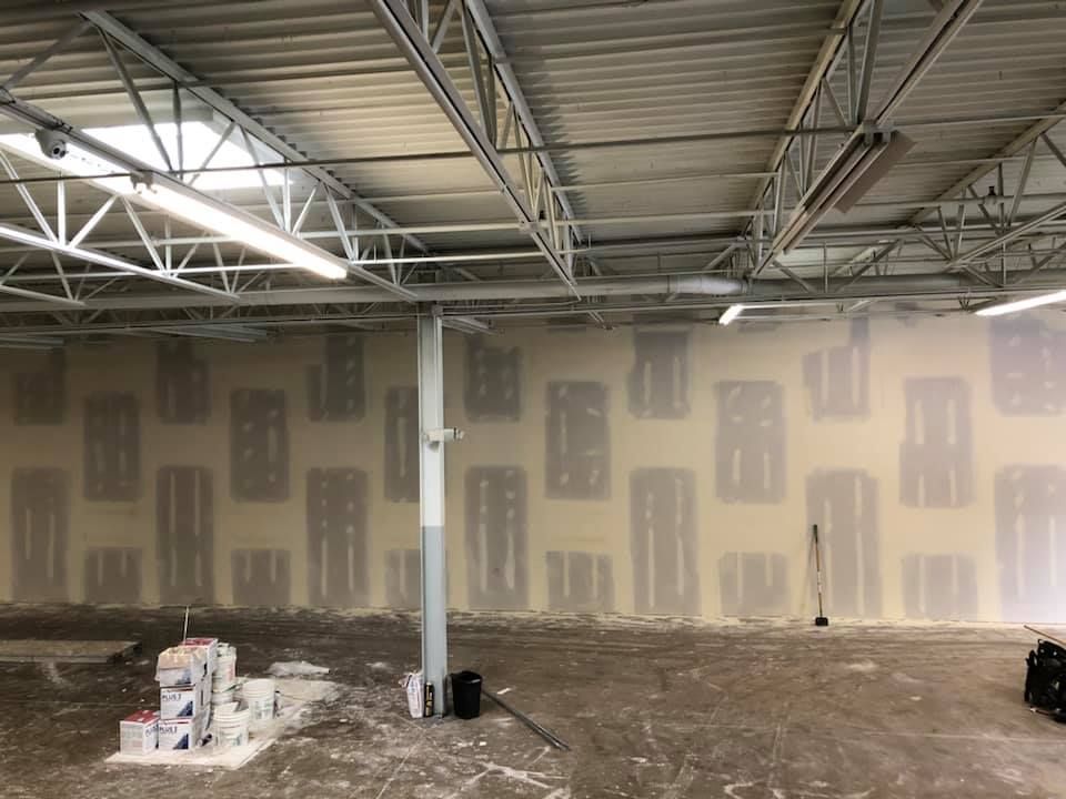 A large empty room with a lot of walls and a ceiling.