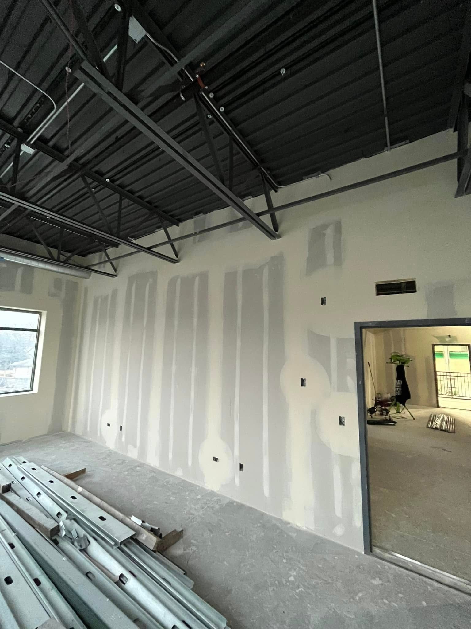 A room with a lot of drywall and a ceiling.