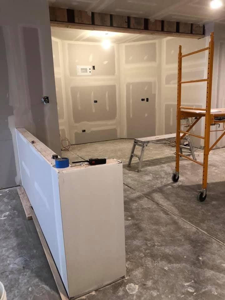 A room under construction with a scaffolding and a ladder.