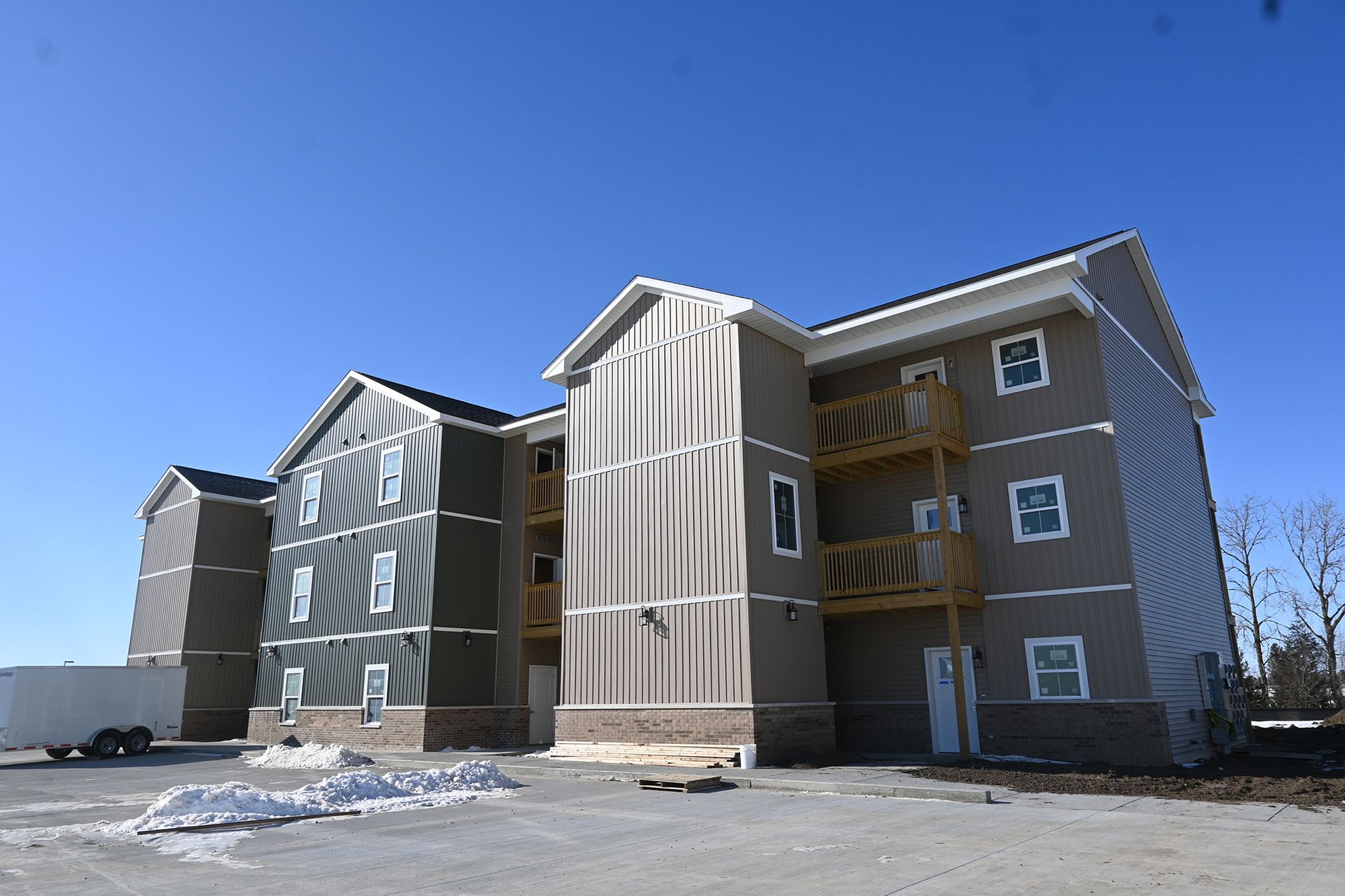A large apartment building with a lot of windows is being built.