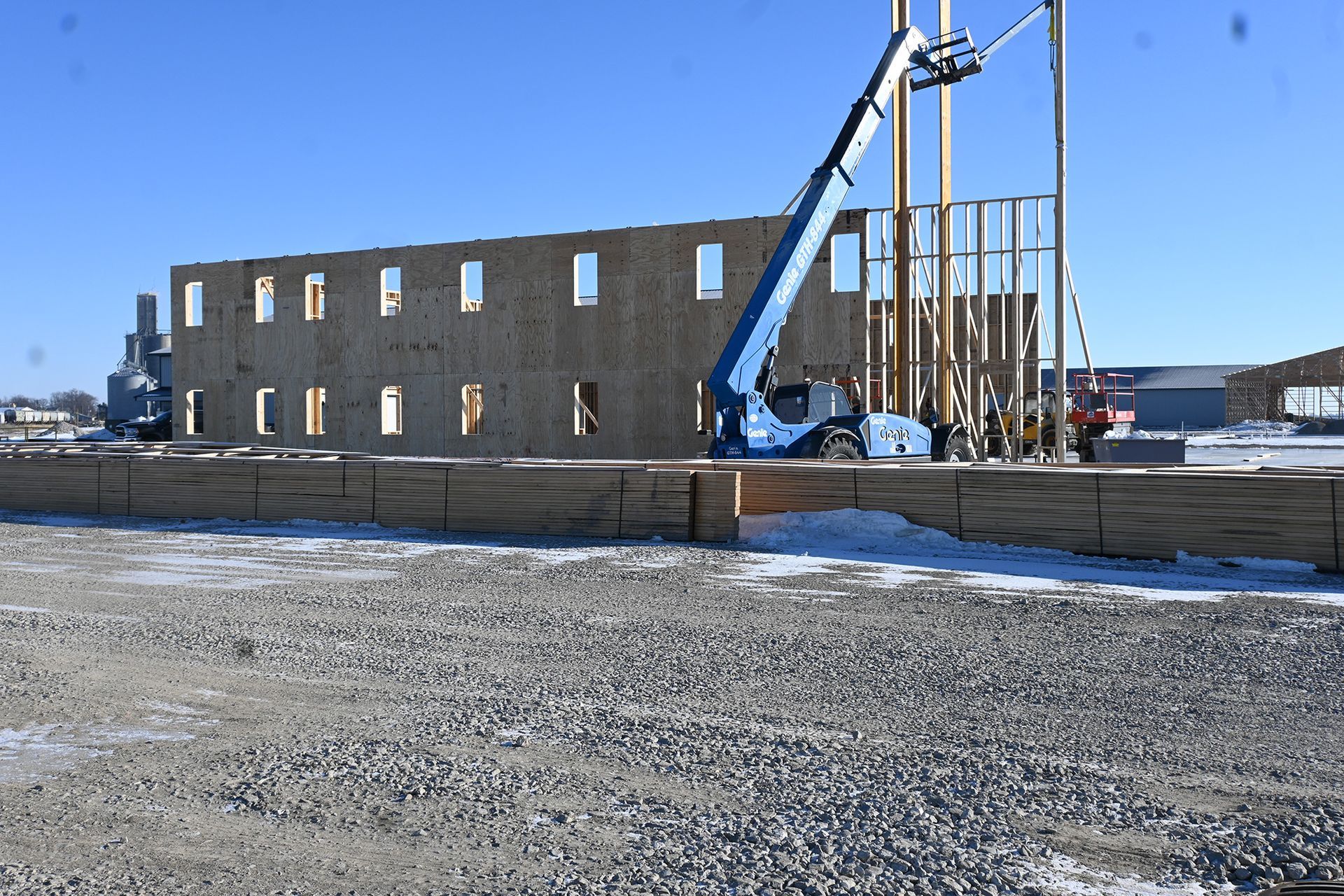 A large building is being built with a crane in the foreground.