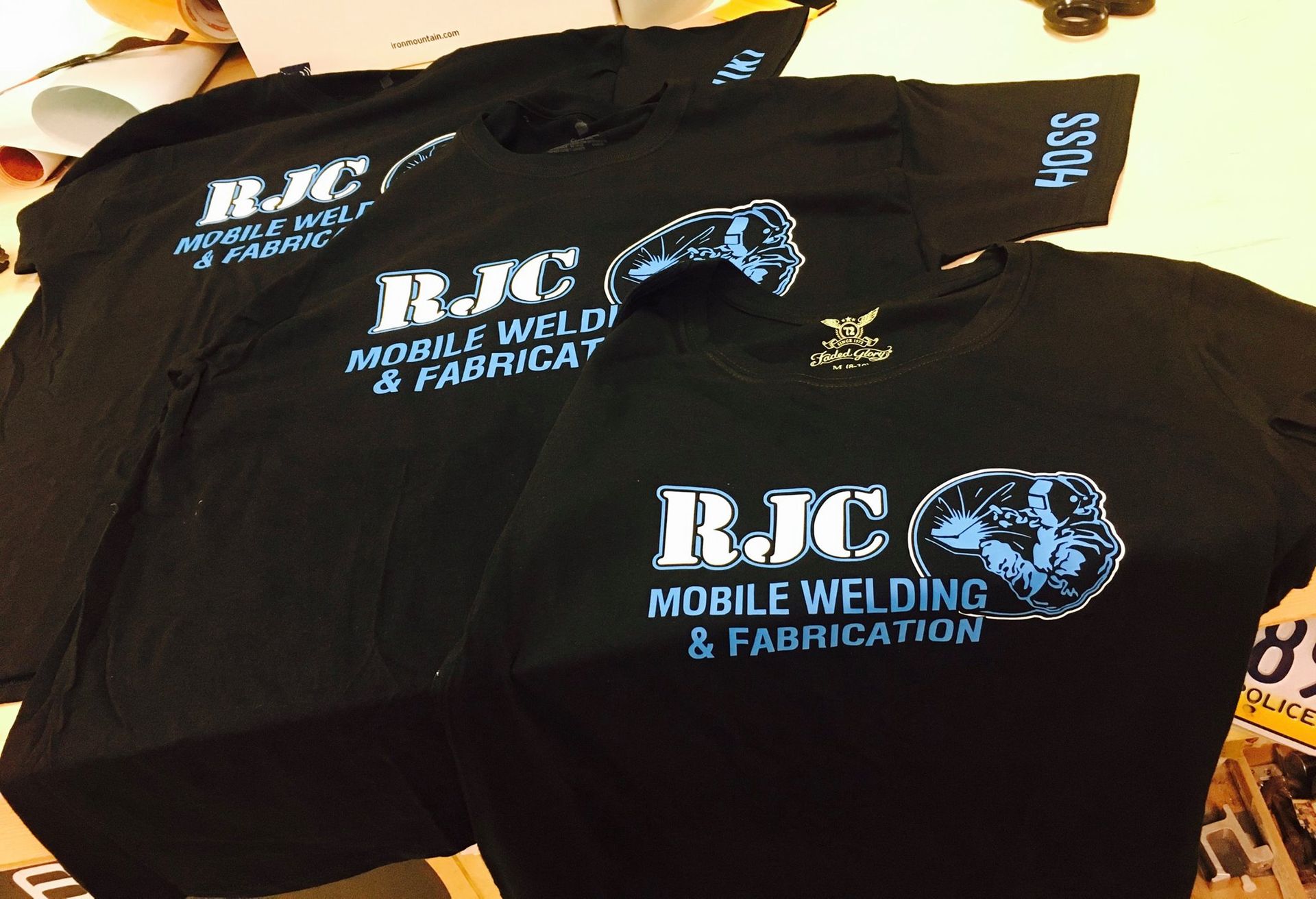Three black rjc mobile welding and fabrication t-shirts